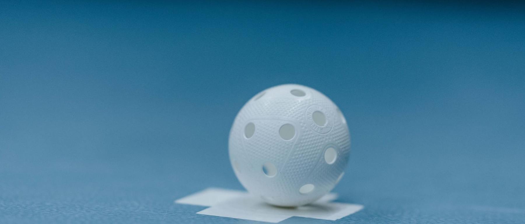 einzelner Unihockey-Ball auf dem Spielfeld. Foto: swissunihockey